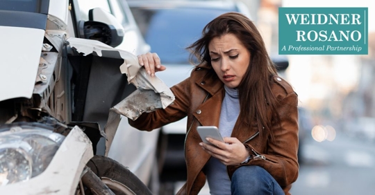 woman contacting someone after being in an accident